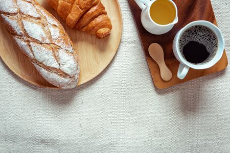 Traditional Breakfast Natural Vegetarian Food With Sourdoughs Bread, Coffee, Honey, Croissant on The Table., Homemade Freshly Baked French Sourdough Loaf for Breakfast. Food and Beverage Conceptの写真素材