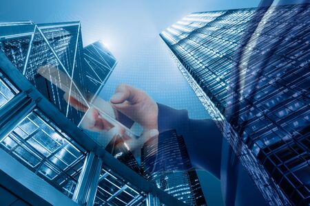 Business Technology Telecommunication and Communication Network Connection Concept, Double Exposure of Businesswoman Using Mobile Phone for Communicating Information With Cityscape Background.の写真素材