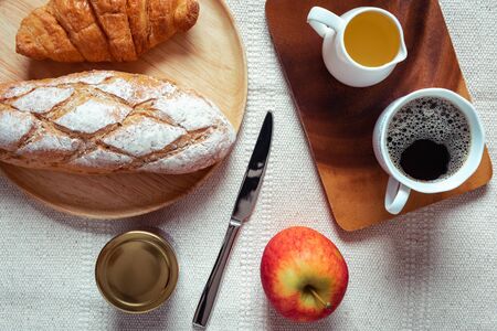 Breakfast Natural Vegetarian Food With Sourdoughs Bread Bakery, Coffee, Honey, Croissant, Apple Fruit on Table., Homemade Fresh Baked French Sourdough for Breakfast. Food Nutrition/Beverage Conceptの写真素材