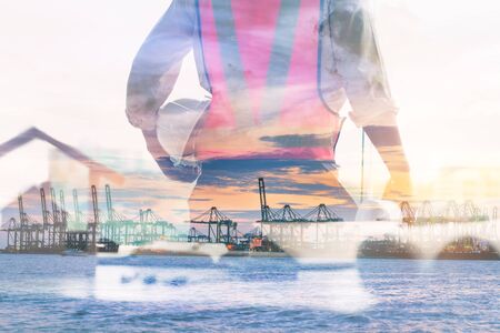 Double Exposure of Engineer in Safety Equipment on Shipping Terminal Industry Background, Technician Man Operator of Handling Container Shipment Freight. Business Transportation and Logistics Industryの写真素材
