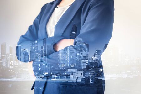 Double Exposure of Smart Businesswoman With City Skyscraper Building Background, Entrepreneur Business People of Financial Banking and Stock Investment. Trade Finance and Professional Invest Conceptの写真素材