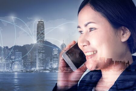 Telecommunication and Communication 5G Network Concept, Double Exposure of Business Woman is Using Smart Phone for Calling Communicated and City Urban Background. Innovative 5G Networking Mobile Phoneの写真素材