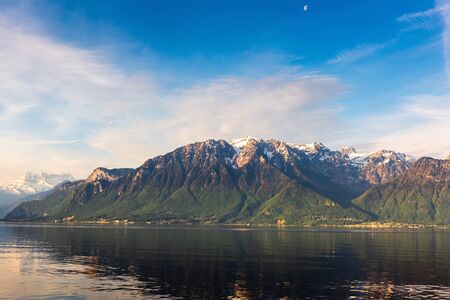 Natural Landscape Scenery View of Lake Geneva and Swiss Alps at Switzerland, Nature Scenic Horizontal Waterfront of Lake at Sunrise, Panoramic Lakeside of Geneva in Spring Season at Vevey, Switzerlandの写真素材