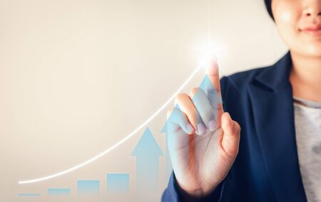 Businesswoman is Tracking Chart Info On The Screen, Investor Drawing Projection Trend of Stock Gantt Chart for Investing Information. Business Financial Analyzing Investment and Stock Market Conceptの写真素材