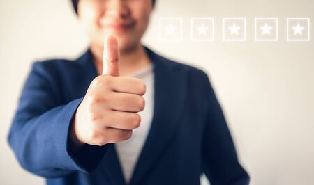 Business Woman Accountant Giving Thumbs Up While Looking at Camera, Close-Up Portrait of Businesswoman Showing Raise Hands and Thumbs Up for Good Satisfaction Attitude. Business Financial/Accounting.の写真素材