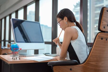 Beautiful of Business Accountant Woman Concentrate Serious in Workplace,  Businesswoman is Working on Her Table Desktop in Office Workspace, Accounting Occupation and Career Concept.の写真素材
