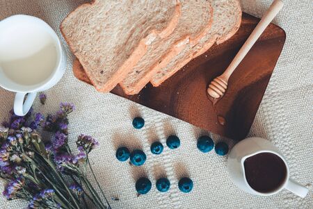 Breakfast Nature Vegan Vegetarian Food With Milk, Honey, Bread and Natural Fresh Fruit on a Table....