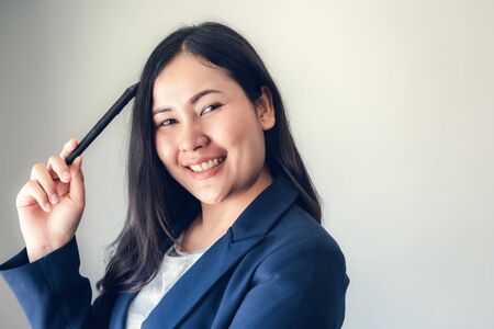 Creative Thinking and Business Entrepreneur Concept, Portrait of Confident Businesswoman Posing on Isolated and Copy Space Background. Smart Business Woman is Happy Expression While Creativity Idea.の写真素材