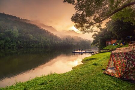 Beautiful Natural Scenic of National Park and Riverside Camping at Sunrise, Landscape Nature View of Campsite at Morning Sunlight. Outdoor Leisure Activity and Travel Place of Tourism.の写真素材