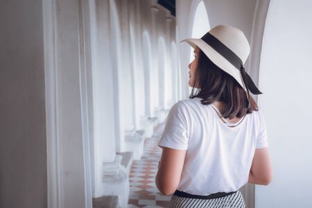 Tourist Woman Having Enjoyment While Sightseeing Art Architecture in The Temple, Portrait of Traveler Asian Woman is Visiting Fine Art Painting of Buddha Stories in Spiritual Place. Travel/Lifestylesの写真素材