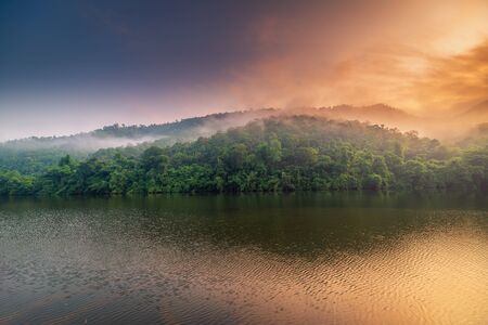 Beautiful Natural Scenic of Lake and Mountain at Sunrise, Landscape Nature View of Campsite at Morning Sunlight. Outdoor Leisure Activity and Travel Place of Tourism.の写真素材