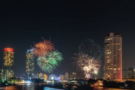Beautiful of Fireworks Anniversary New Year Celebration With Cityscape Scenery of Bangkok City, Thailand. Amazing Scenic of Colorful Firework Over Chao Phraya River During New Year's Eve Midnight.の写真素材