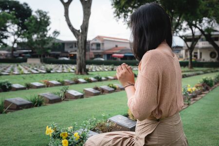 Close-Up of Religious Christian Woman Hands Clasped While Honoring and Praying to Military in War...