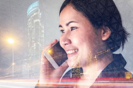 Telecommunication and Communication 5G Network Concept, Double Exposure of Business Woman is Using Smart Phone for Calling Communicated and City Urban Background. Innovative 5G Networking Mobile Phoneの写真素材