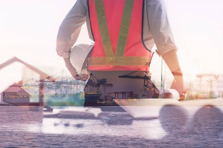 Double Exposure of Engineer in Safety Equipment on Shipping Terminal Industry Background, Technician Man Operator of Handling Container Shipment Freight. Business Transportation and Logistics Industryの写真素材