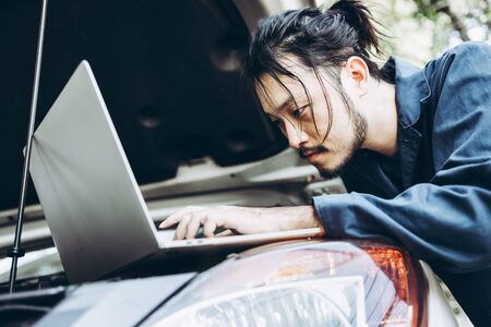 Mechanic Car Service Man is Working in Garage Workshop, Technician Automotive is Inspection Checking...