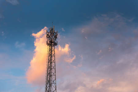 Communication Antenna Tower for Telecommunication Network Against Blue Sky Background on Sunrise. Technology Cellular and Transmission Connection of Telecom, Satellite Broadband Structure Station.の写真素材