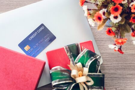Shopping Online and Holiday Celebration Concept, Present Gift Box and Credit Card on Laptop. Celebrate Anniversary Greeting Presents Eventの写真素材