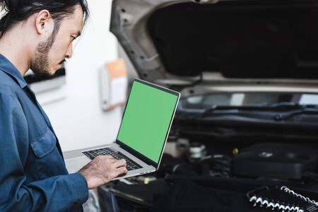 Mechanic Car Service Man is Working in Garage Workshop, Technician Automotive is Inspection Checking Mechanical Car Engine and Estimate Fixing Cost for Customer. Auto Services and Maintenance Conceptの写真素材