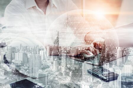 Construction Engineer Using Computer for Project Planning and Management, Double Exposure of Architect Projects is Working Civil Engineering Design With City Real Estate Background. Computing Networkの写真素材
