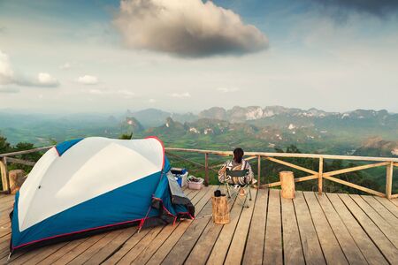 Landscape Scenery Mountains View With Camping Tent on Wooden Terrace for Outdoors Leisure Activity Relaxation. Beautiful Scenic of Nature From Camp Site Viewpoint, Adventure/Vacation Lifestylesの写真素材