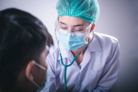 Medical Patient Healthcare and Doctor Occupation Concept, Medicine Physician Doctor Examining Patients Physical Health by Stethoscope in Hospital Clinic Health Care. Cardiologist Specialist Doctorsの写真素材
