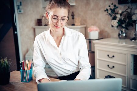 Work From Home Lifestyle and Business Online, Attractive Woman is Using on Laptop While Working at Home. Business Freelance Person Communication Via Internet Network at Her Home, New Normal Lifestylesの写真素材