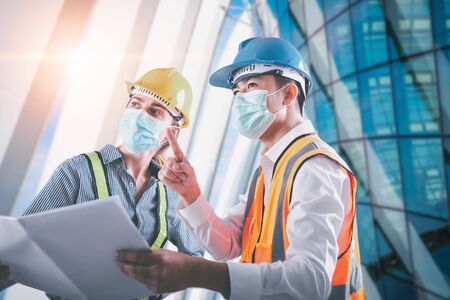 Construction Engineer/ Architect Builder Teamwork Inspection Civil Work at Construction Site, Engineering Inspector Team in Safety Equipment Discussing about Constructing Plan for Steel Architecture.の写真素材