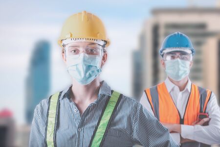 Coronavirus Covid-19 Disease Epidemic Crisis Situation, Construction Worker Standing in Line for Fever Body Scanning Thermometer Scan at Construction Site.Corona-Virus Covid19 Prevention of New Normalの写真素材