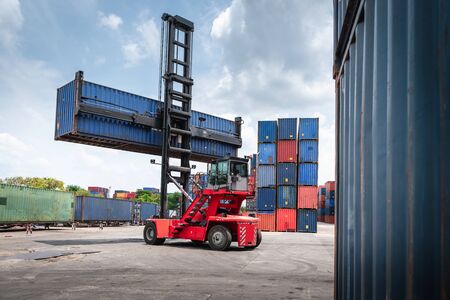 Container Cargo Port Ship Yard Storage of Logistic Transportation Industry. Forklift is Stacking Containers of Freight Import/Export Shipment. Business Shipping Logistics Service Transport Industrialの写真素材