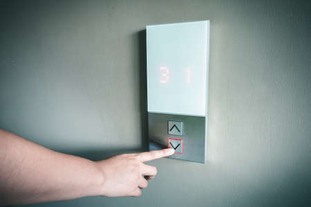 Closeup of Woman Hand is Pressing Elevator Button for Access to Office Building, Electrical Lift...