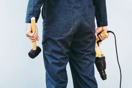 Construction Worker Holding Constructing Equipment Tools on Isolated Background. Carpenter Man Builder Real Estate Jobs Occupation, Business Engineering Industry and Building Development Concept.の写真素材