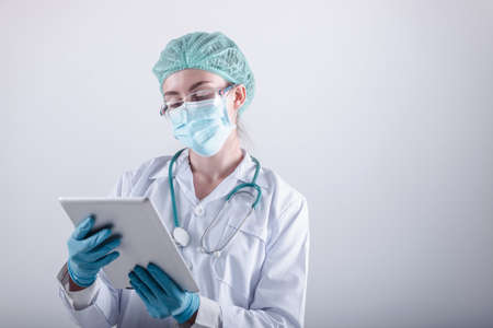 Medical Surgical Doctor and Health Care, Portrait of Surgeon Doctor in PPE Equipment on Isolated Background. Medicine Female Doctors Wearing Face Mask and Cap for Patients Surgery Work. Medic Hospitalの写真素材