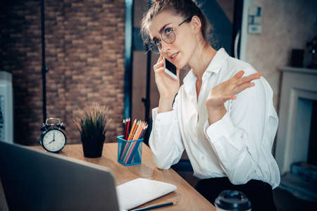 Young Woman Working on Computer Laptop at Home, Businesswoman in Busy Work While Online Conference Virtual Conversation on Laptop From Home. Technology Communication and Creative at Home Conceptの写真素材