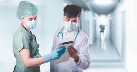 Doctor Team Discussion Patient Diagnosis Report on Tablet Against Patients Ward Background, Group of Doctors Teamwork in Medical Equipment Working in Clinic Surgical Hospital. Healthcare/Medicineの写真素材