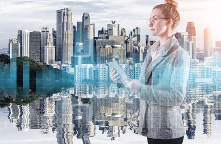 Business Woman Using Tablet on City Urban Background, Double Exposure of Businesswoman With Financial Marketing Report Data Against Cityscape Building Backgrounds. Business Digital Finance/Technologyの写真素材