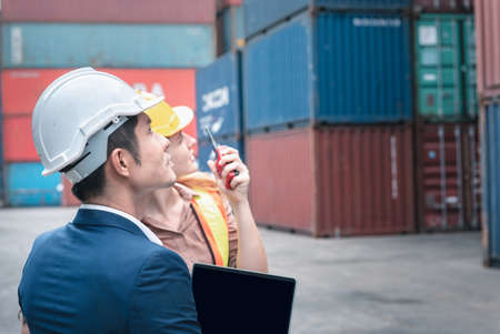 Container Shipping Logistics Engineering of Import/Export Transportation Industry, Transport Engineers Teamwork Controlling Management Containers Together at Port Ship Loading Dock. Business Teamの写真素材