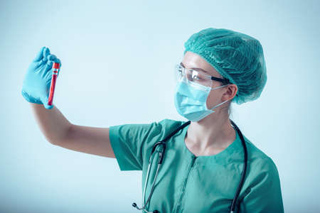 Lab Scientist Woman is Working in Scientific Chemical Laboratory, Female Medicine Science is Diagnosing  Blood in Sample Tube for Experiment Biology in Clinic Laboratory. Healthcare/Medicalの写真素材