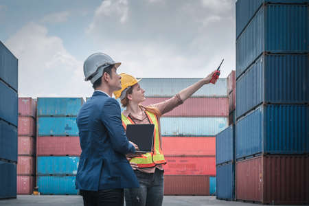 Container Shipping Logistics Engineering of Import/Export Transportation Industry, Transport Engineers Teamwork Controlling Management Containers Together at Port Ship Loading Dock. Business Teamの写真素材