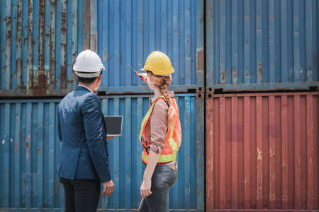 Container Shipping Logistics Engineering of Import/Export Transportation Industry, Transport Engineers Teamwork Controlling Management Containers Together at Port Ship Loading Dock. Business Teamの写真素材