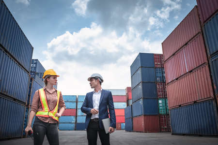 Container Shipping Logistics Engineering of Import/Export Transportation Industry, Transport Engineers Teamwork Controlling Management Containers Together at Port Ship Loading Dock. Business Teamの写真素材