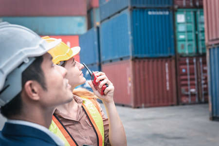Container Shipping Logistics Engineering of Import/Export Transportation Industry, Transport Engineers Teamwork Controlling Management Containers Together at Port Ship Loading Dock. Business Teamの写真素材
