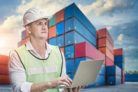 Container Supervisor Control Import/Export While Inspecting Containers Box in Warehouse Storage Distribution. Container Logistics Shipping Controlling of Transportation Industry, Cargo Ship Factoryの写真素材