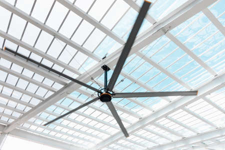 Ventilation Electrical Ceiling Fan Indoor Hall of Building, Luxury Modern Architecture Roofing Transparent Grass and Structure Metal Frame. Electric Ventilator Fan Against Geometric Structures Frameの写真素材