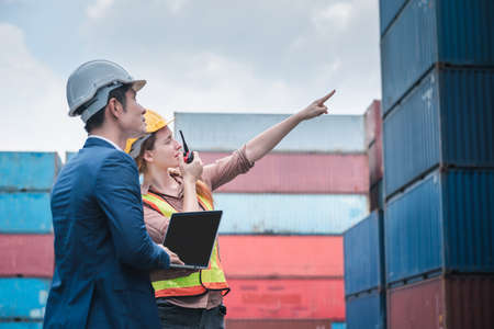 Container Shipping Logistics Engineering of Import/Export Transportation Industry, Transport Engineers Teamwork Controlling Management Containers Together at Port Ship Loading Dock. Business Teamの写真素材