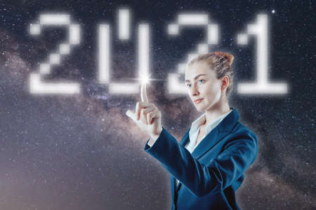 Businesswoman pushing start button of the year 2021の写真素材