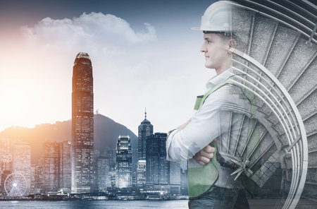Infrastructure Construction Building and Engineering Futuristic Concept, Double Exposure of Construction Engineer With Modern Architecture City Skyscraper. Future Building Service and Architect Workの写真素材