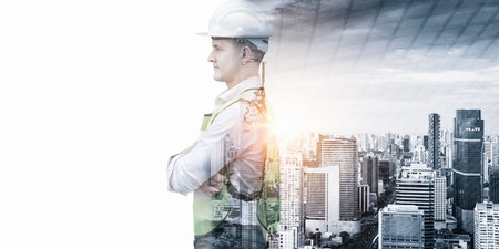 Infrastructure Construction Building and Engineering Futuristic Concept, Double Exposure of Construction Engineer With Modern Architecture City Skyscraper. Future Building Service and Architect Workの写真素材