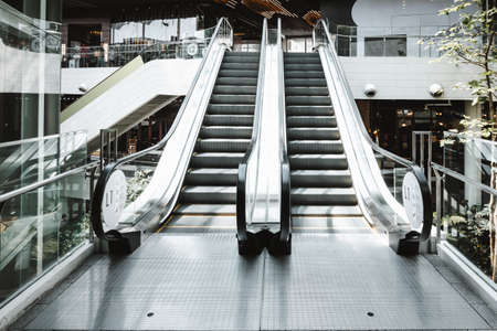 Stairway Electric Escalator of Shopping Mall, Modern Indoor Escalators and Interior Decoration in Shopping Supermarket. Perspective View of Empty Luxury Staircase Escalator, Facility Building.の写真素材