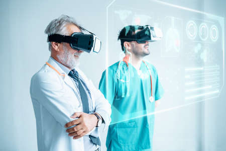 Futuristic Medical Diagnose Through Virtual Reality Glasses Simulator and Screen Interactive, Doctor Team Disease Diagnosis Patient Health on 3D VR Headset in Hospital Surgical Room. Medicine Doctorsの写真素材